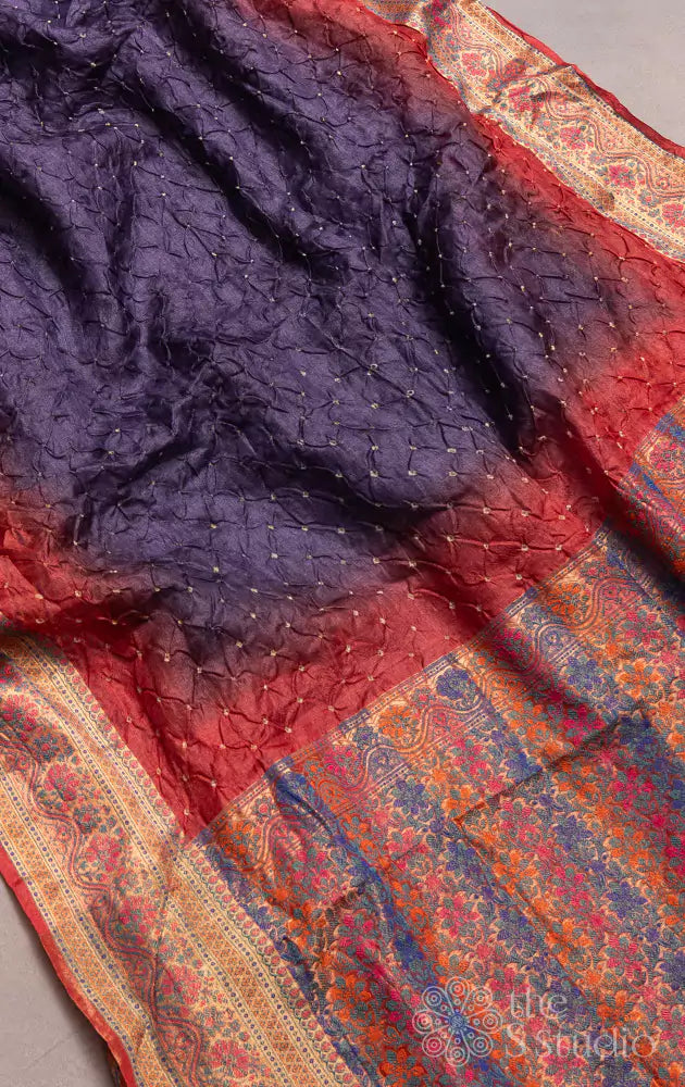 Violet bandhani saree with red border and a brocade pallu