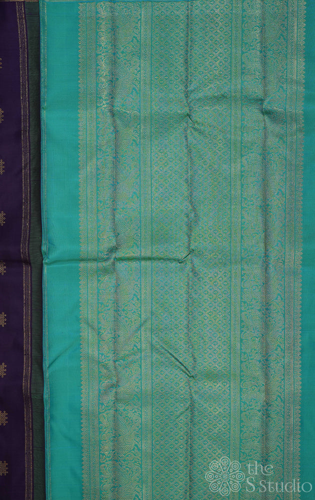 Deep violet colour kanjivaram saree with kolam buttas and sea green pallu