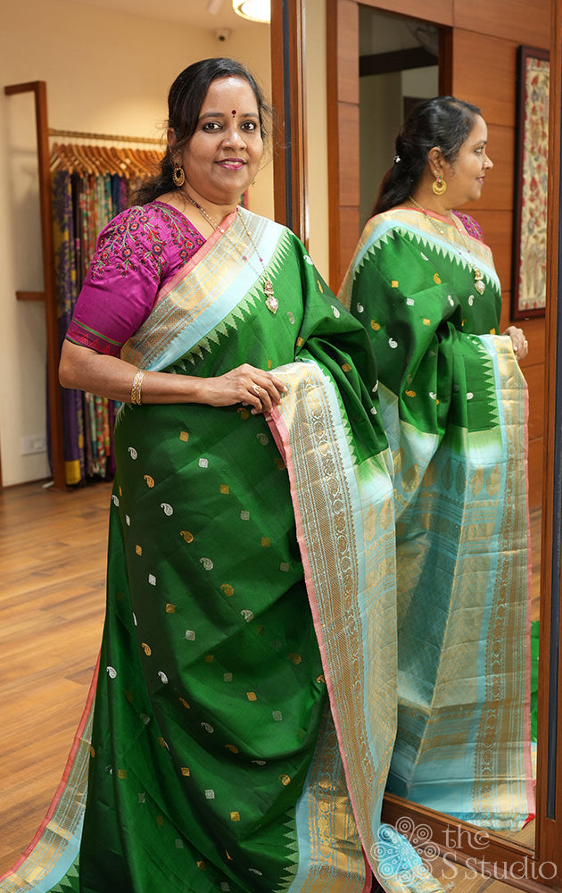 Bottle green Gadwal silk saree with light blue temple border