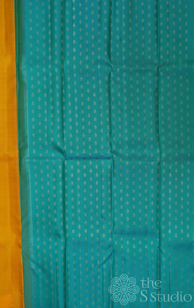 Mustard partly pallu kanjivaram saree with sea green buttas for pleats and pallu