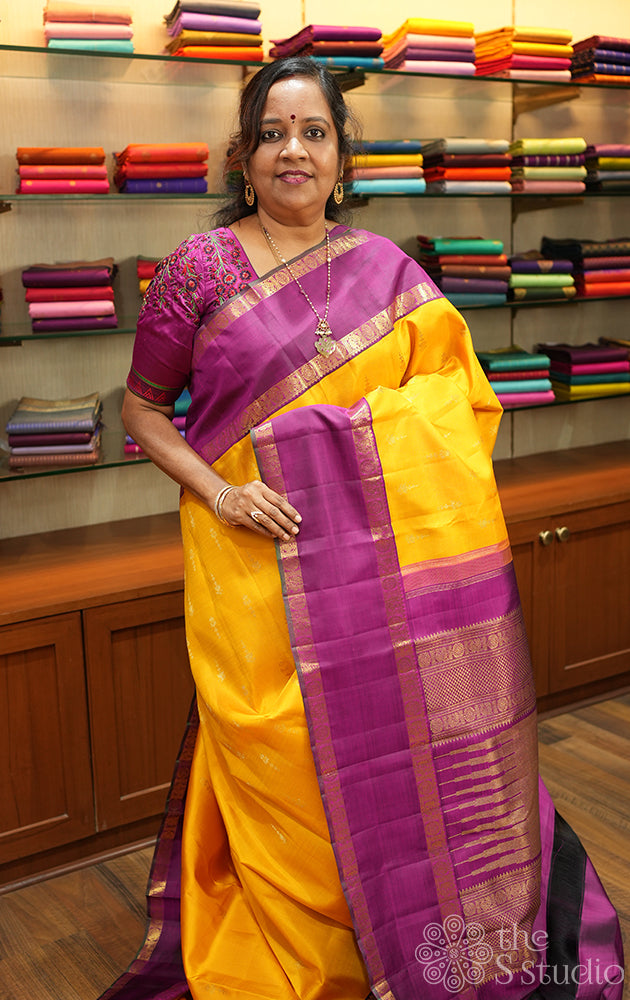 Mustard kanjivaram saree with magenta korvai border