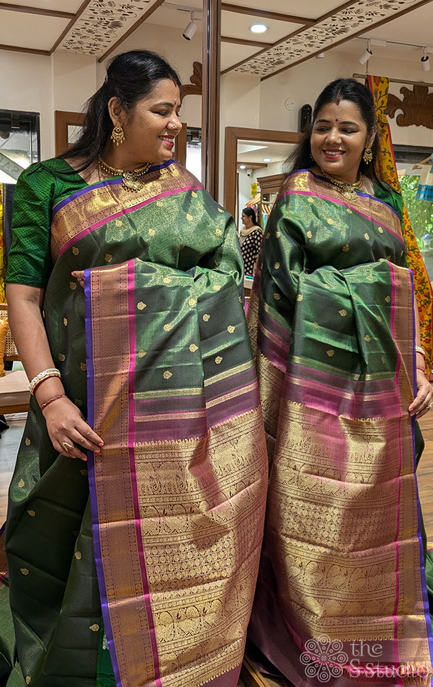 Emerald green vaira oosi kanchi silk saree with rani pink border