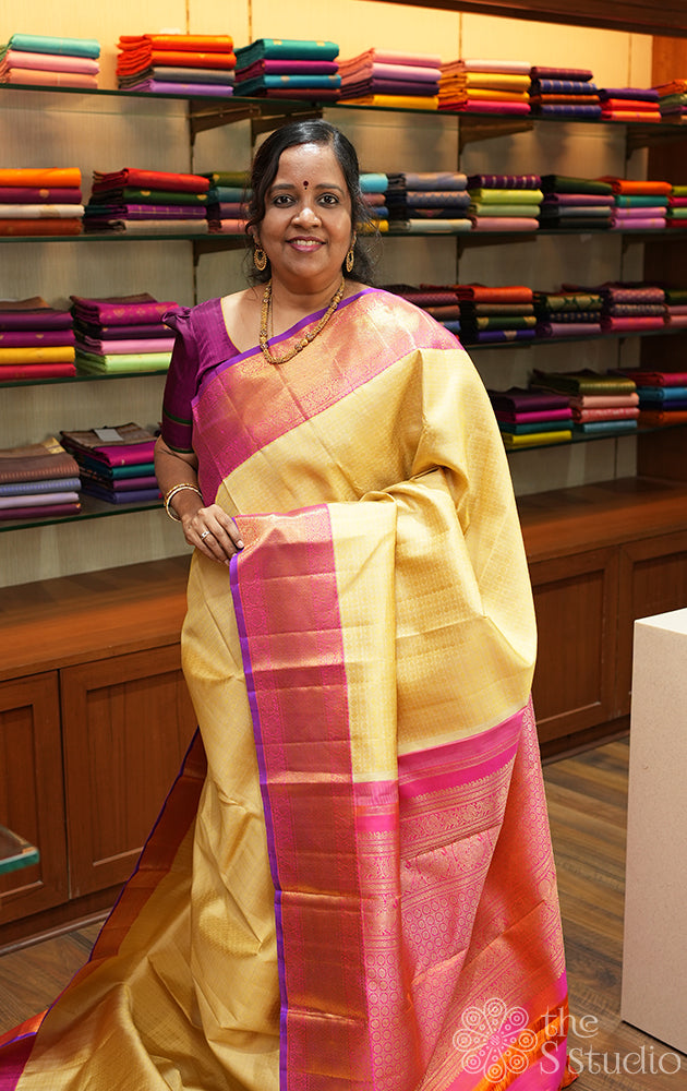 Golden beige kanjivaram silk saree with bright pink korvai border