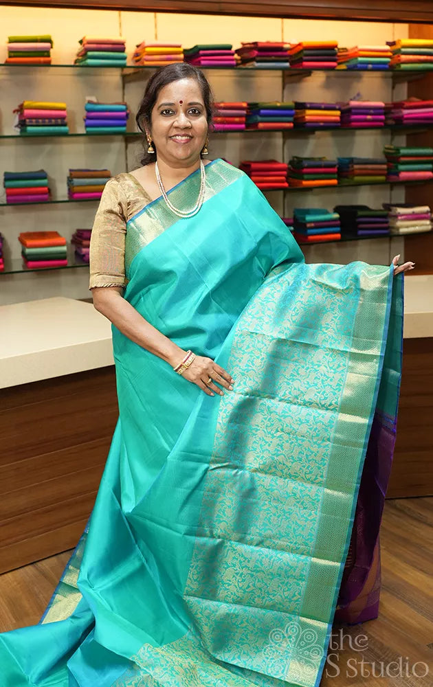 Bluish green kanchi silk saree with vanasingharam design and getti border