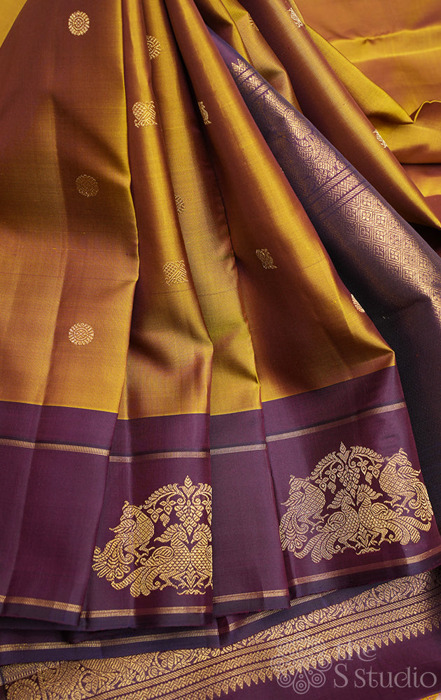 Golden green kanchi pattu saree with deep purple border