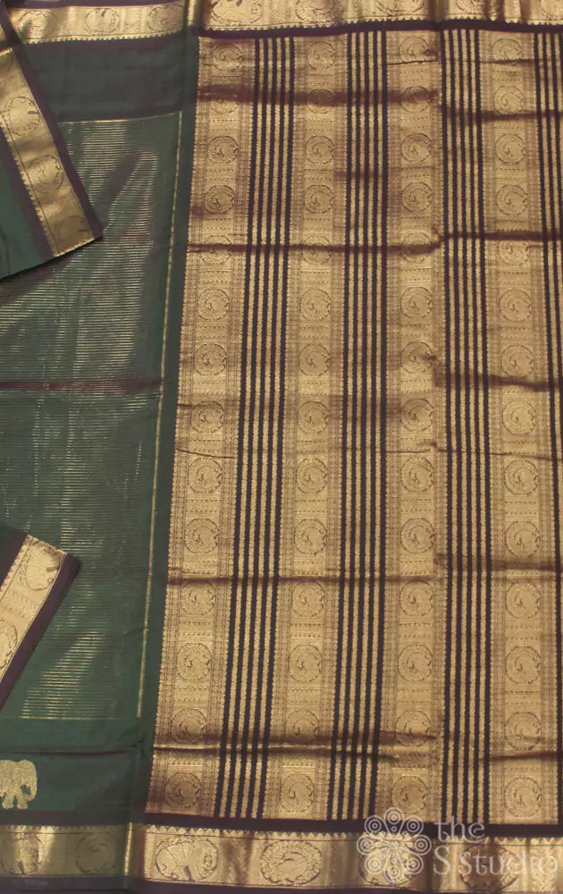 Bottle green silk cotton saree with zari checks and peacock motifs