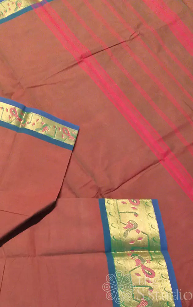 Brown kanchi cotton saree with blue selvedge and a zari border adorned with peacock motifs