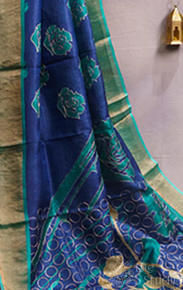 Blue tussar silk saree with floral prints and zari border