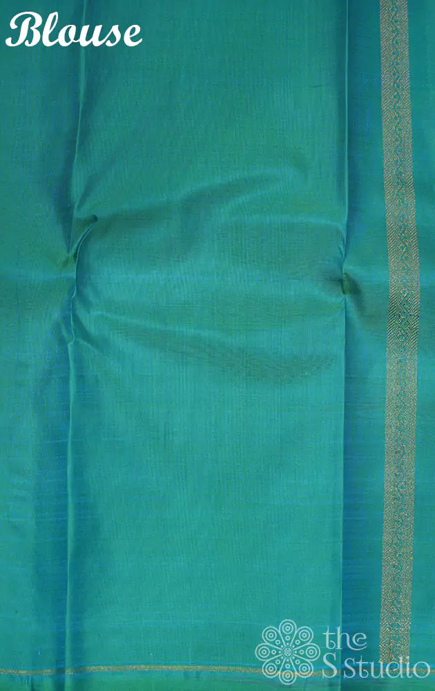 Deep violet colour kanjivaram saree with kolam buttas and sea green pallu