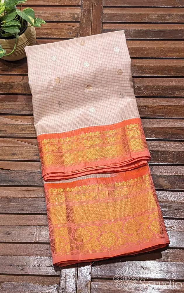 Beige Gadwal silk saree with peach checks and a matching peach border