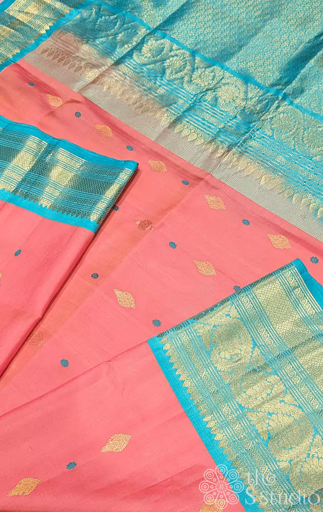 Peachish pink gadwal silk saree with teal blue border