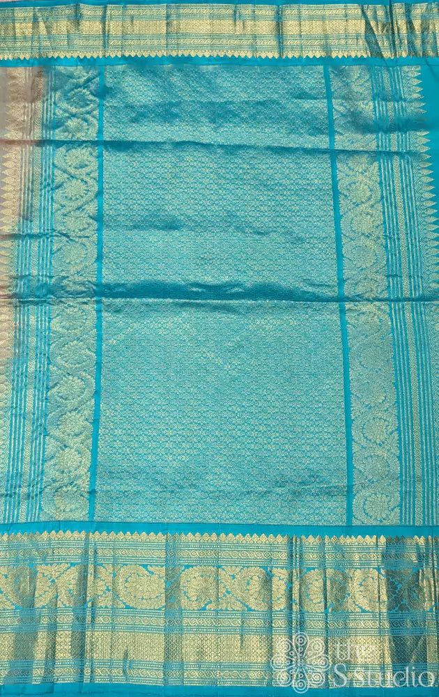 Peachish pink gadwal silk saree with teal blue border