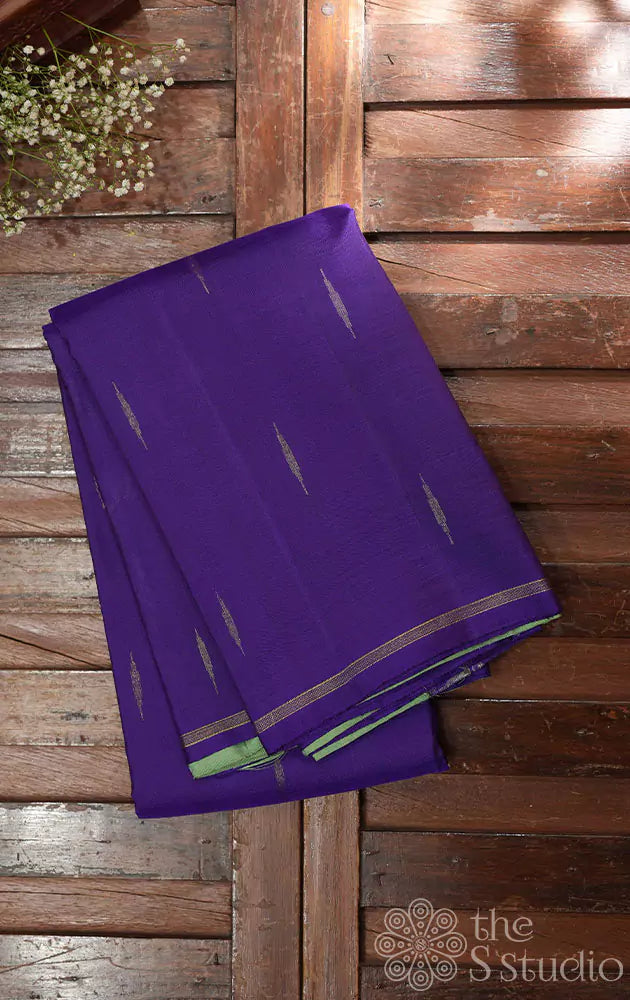 Violet kanchi silk saree with buttas and contrast elachi green pallu