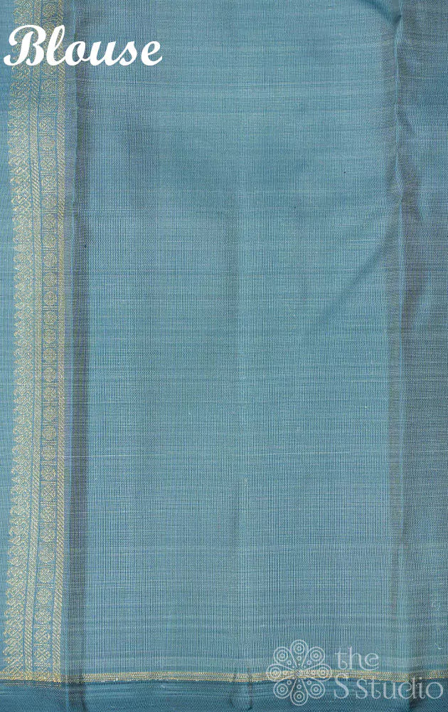 Teal grey kanjivaram saree with zari buttas and a teal blue pallu