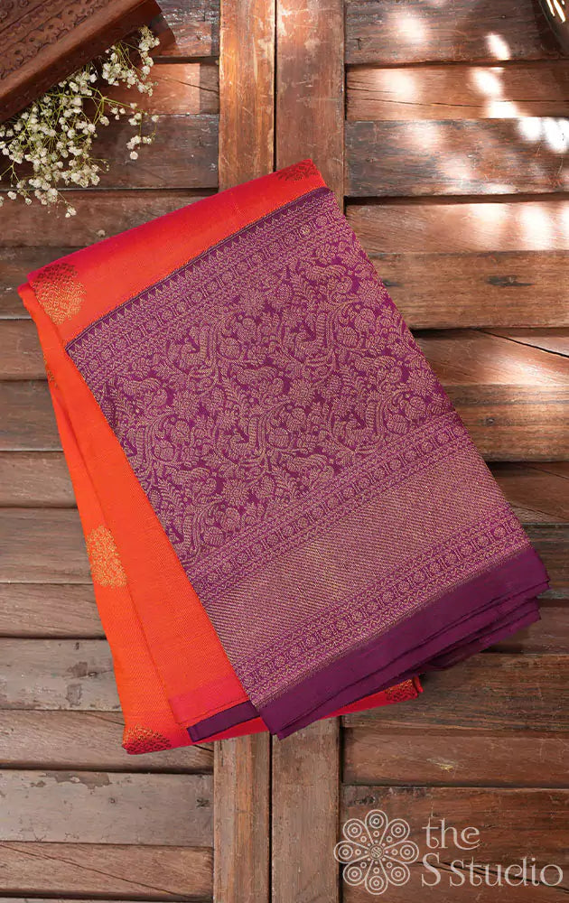 Burnt orange kanjivaram silk saree with a purple korvai border