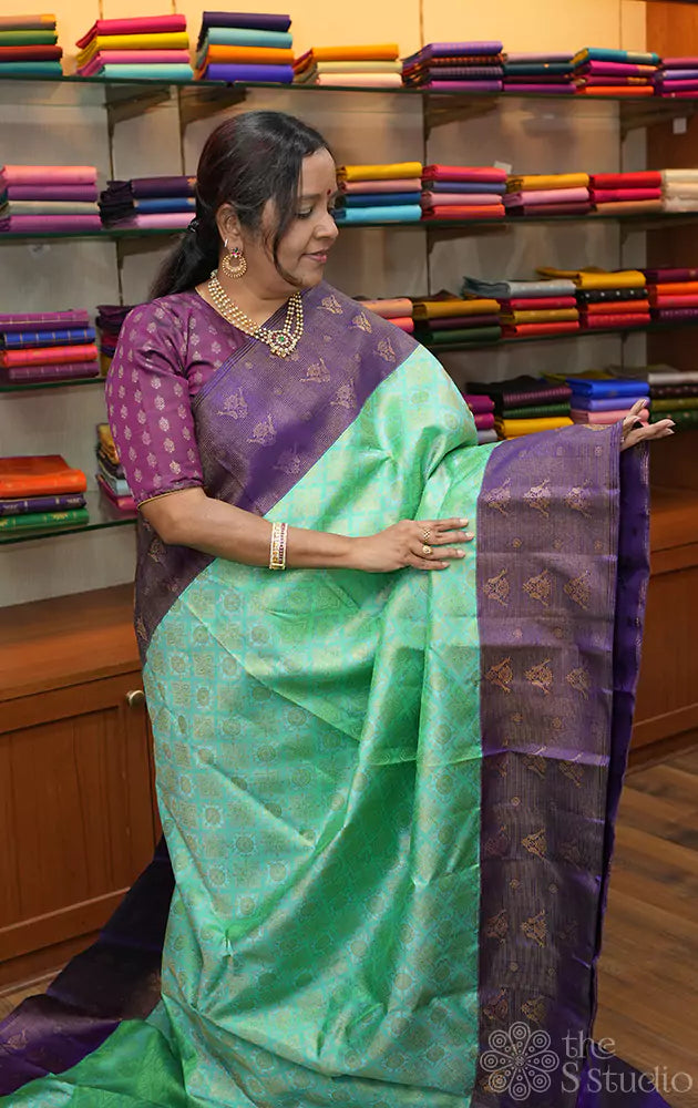 Sea green kanchi silk saree with violet border