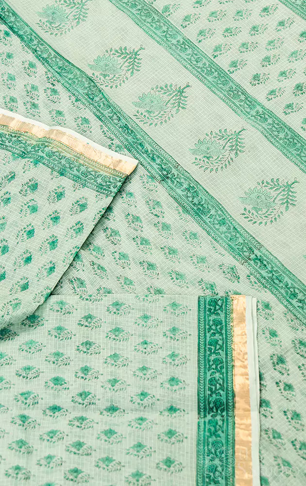 Pastel green kota cotton saree with floral print and zari border