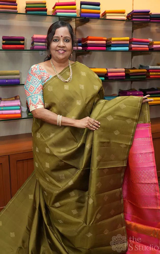 Methi green kanchi silk saree with traditional kolam buttas woven in pure zari