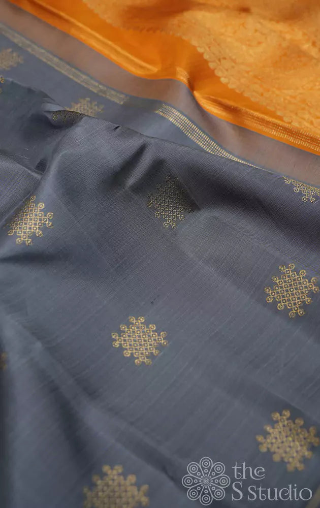 Slate grey kanchi silk saree with traditional kolam buttas woven in pure zari