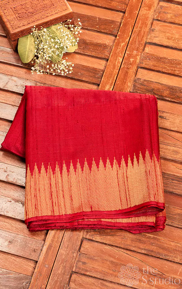 Maroon handwoven raw silk saree featuring a temple zari border.