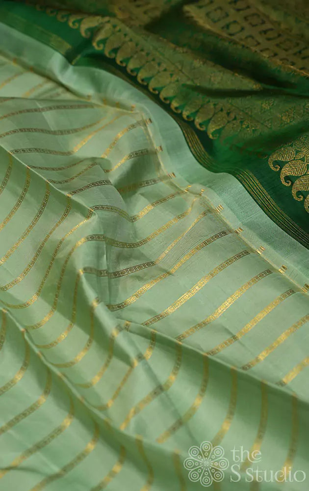 Elachi green kanchi silk saree with zari parallel lines on the body and a contrast green pallu