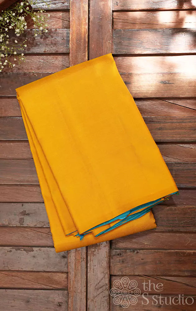 Mustard partly pallu kanjivaram saree with sea green buttas for pleats and pallu