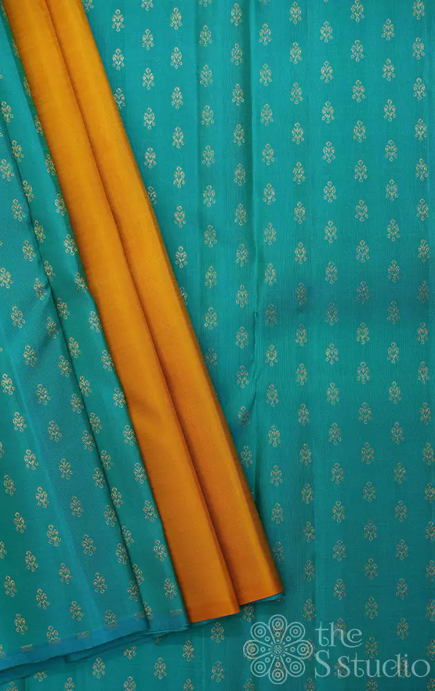 Mustard partly pallu kanjivaram saree with sea green buttas for pleats and pallu