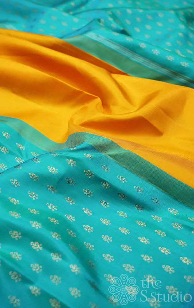 Mustard partly pallu kanjivaram saree with sea green buttas for pleats and pallu