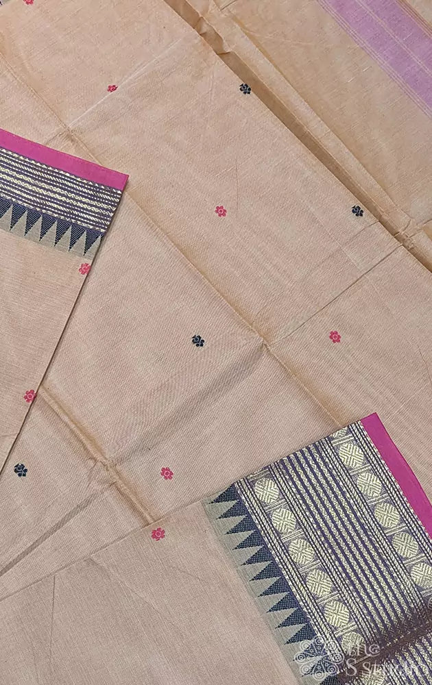 Beige kanchi cotton saree featuring temple border