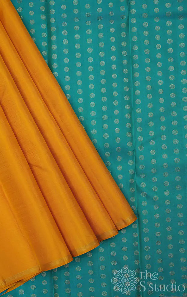 Yellow simple kanchi silk saree with sea green pallu with small buttas