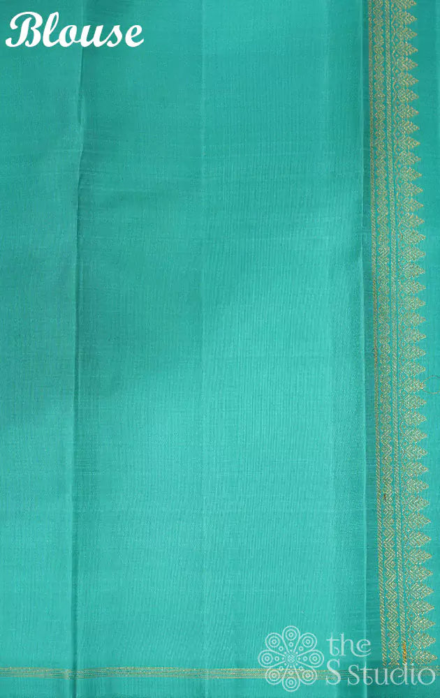 Orange kanjivaram silk saree with kolam buttas and sea green pallu