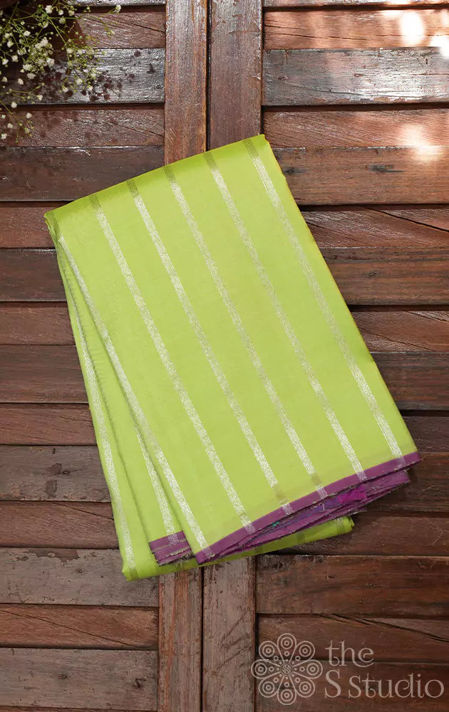 Pastel green kanchipuram silk saree with vertical silver zari lines and contrast pallu