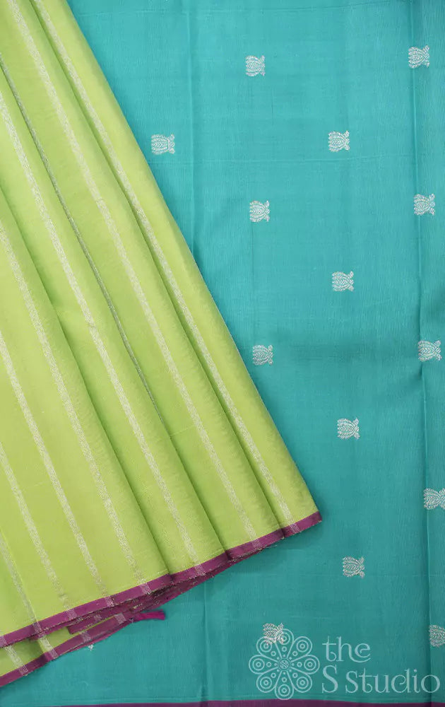 Pastel green kanchipuram silk saree with vertical silver zari lines and contrast pallu