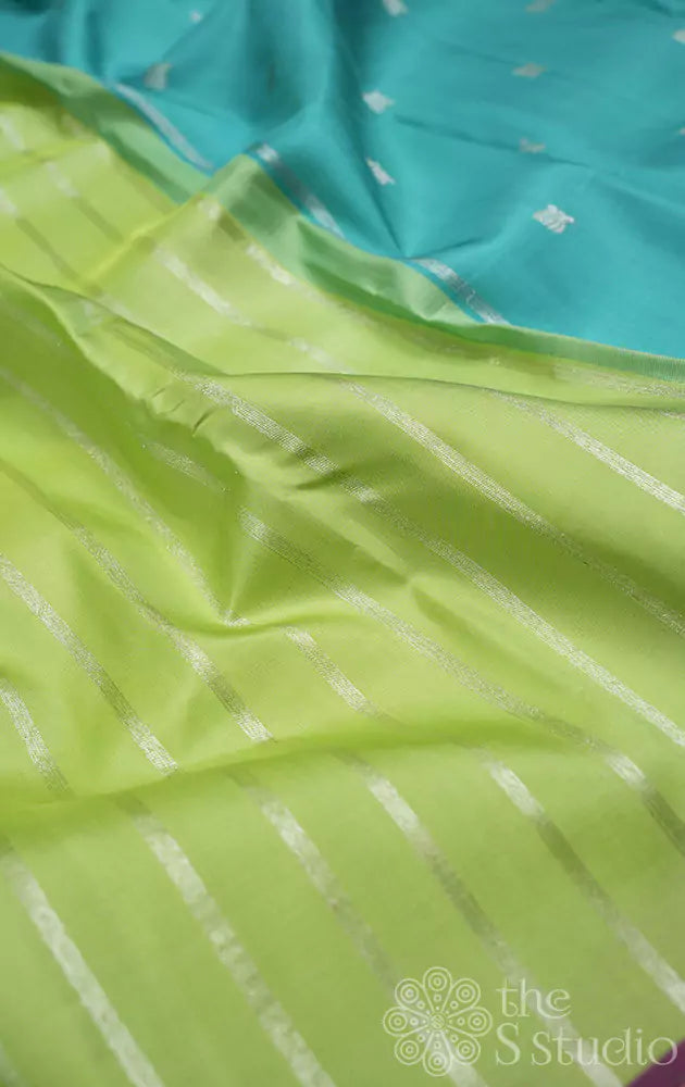 Pastel green kanchipuram silk saree with vertical silver zari lines and contrast pallu