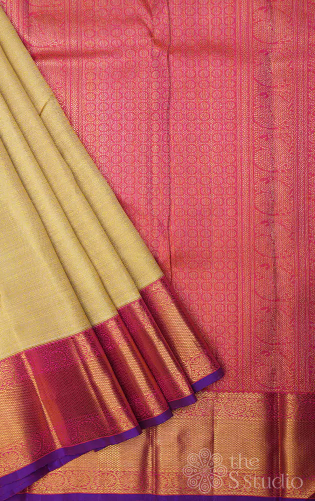 Golden beige kanjivaram silk saree with bright pink korvai border