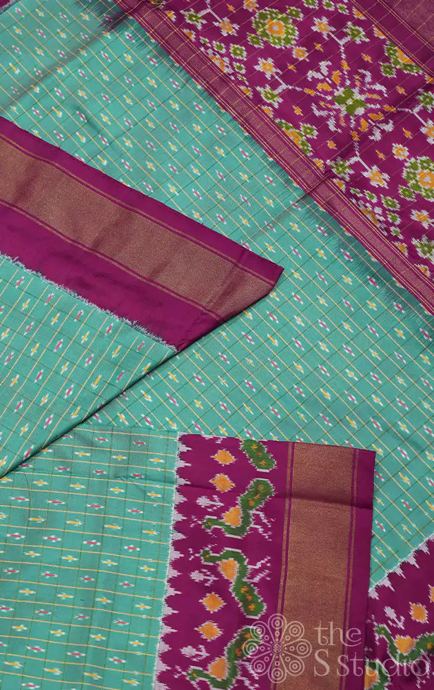 Sea green ikkat silk saree with purple border