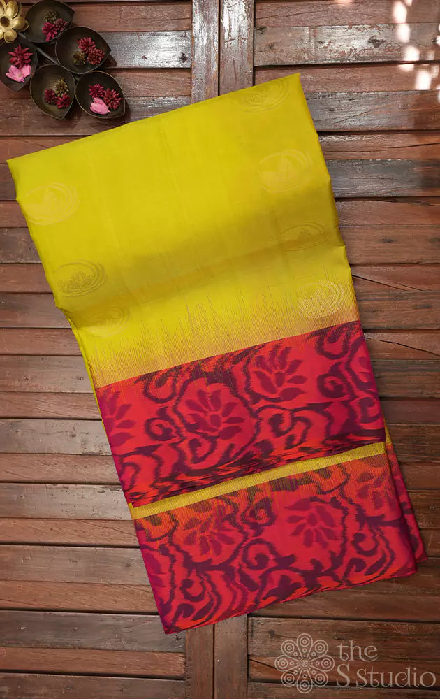 Lime green soft silk saree with peach ikkat woven border