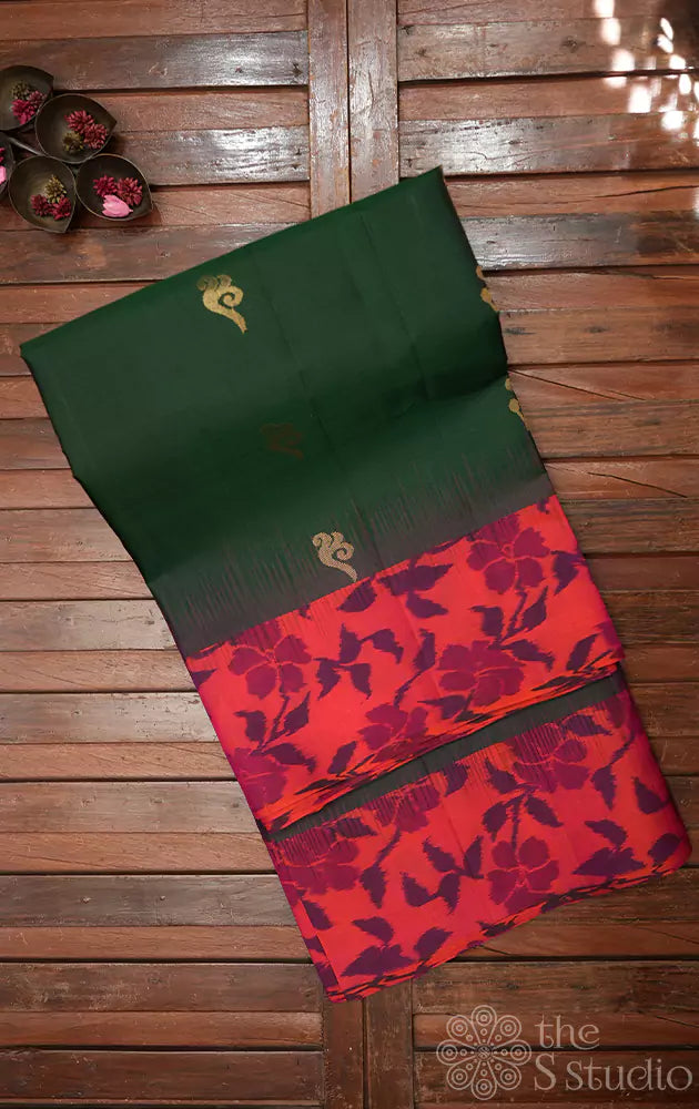 Dark green soft silk saree with peach ikkat woven border