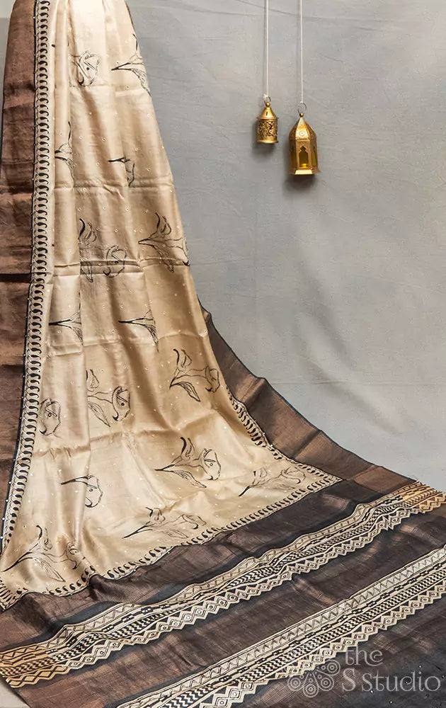 Beige tussar silk saree with black floral prints and hand embroidery