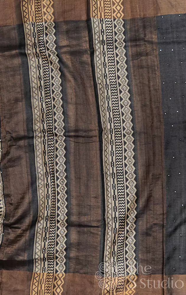 Beige tussar silk saree with black floral prints and hand embroidery