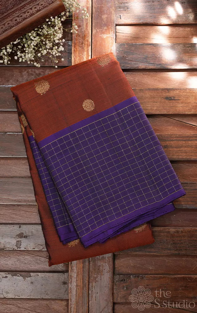 Rust kanchi pattu saree with violet checked border