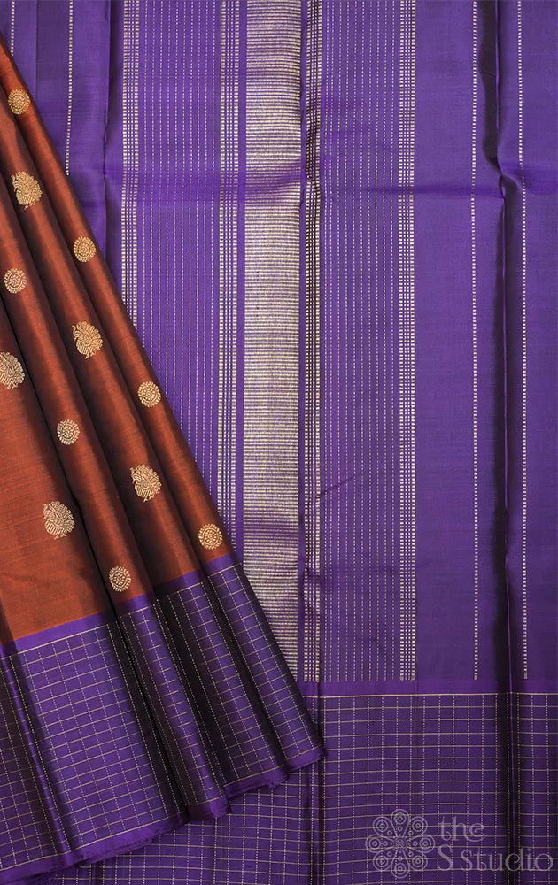 Rust kanchi pattu saree with violet checked border