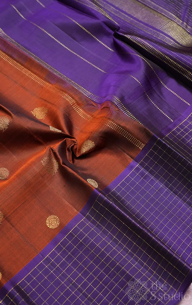 Rust kanchi pattu saree with violet checked border