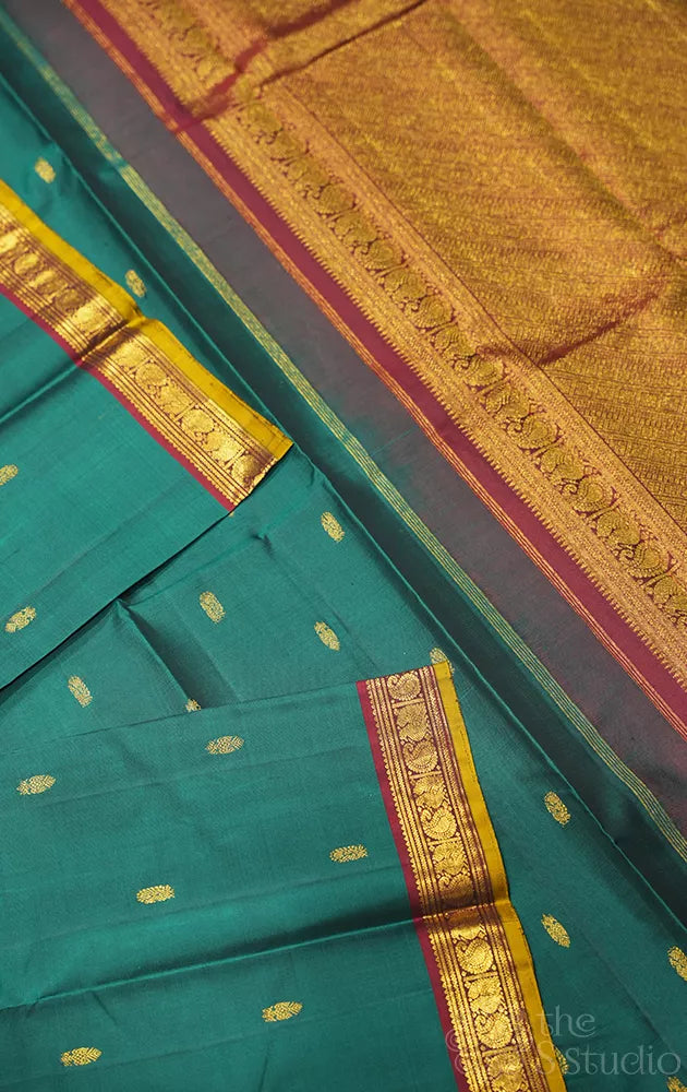 Emerald green kanchipuram silk saree with small zari border