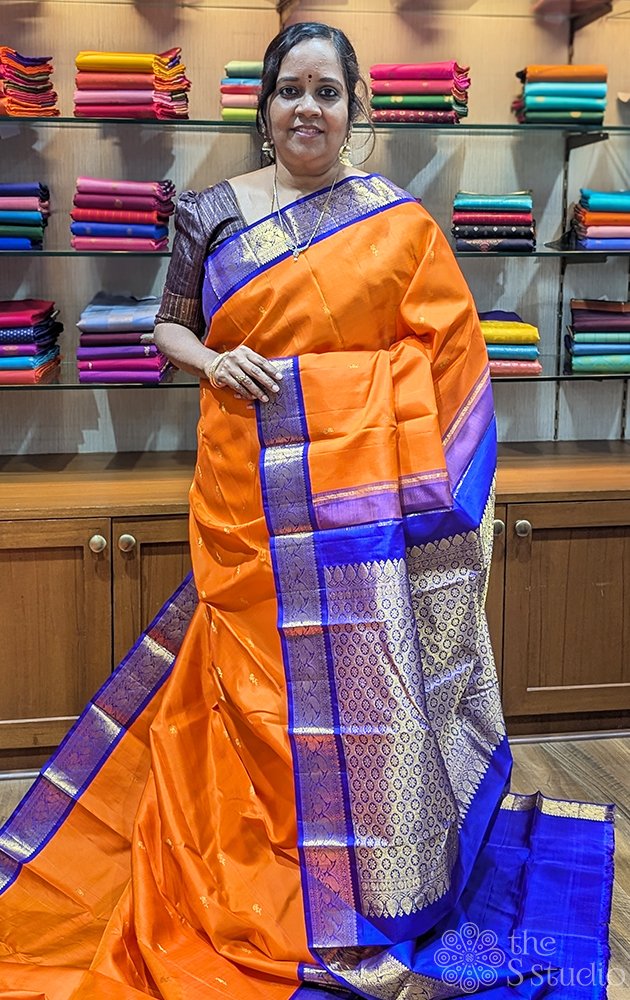 Orange kanchipuram silk saree with Navy Blue korvai border