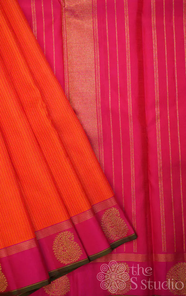 Orange kanchi silk saree with vertical thread lines and pink border