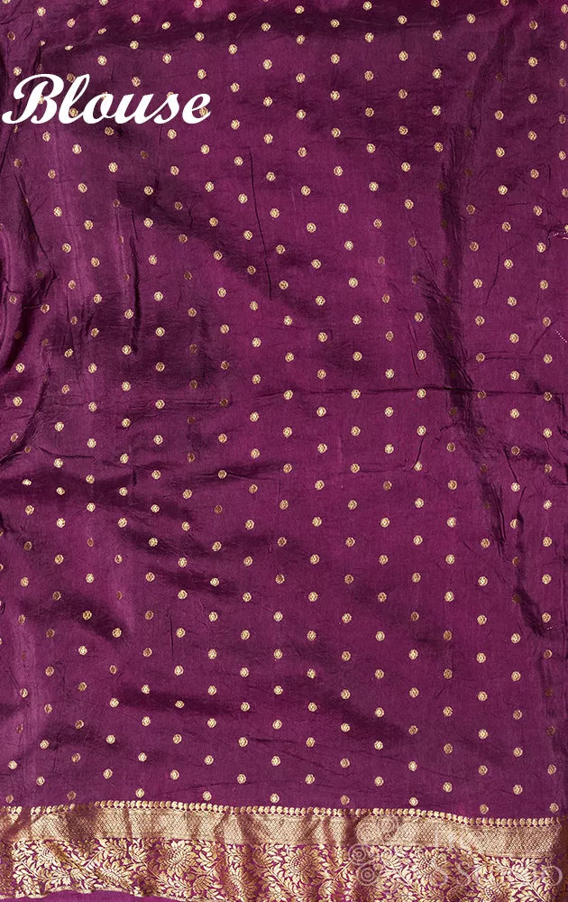Rani pink bandhani semi silk saree with a Purple banarasi border