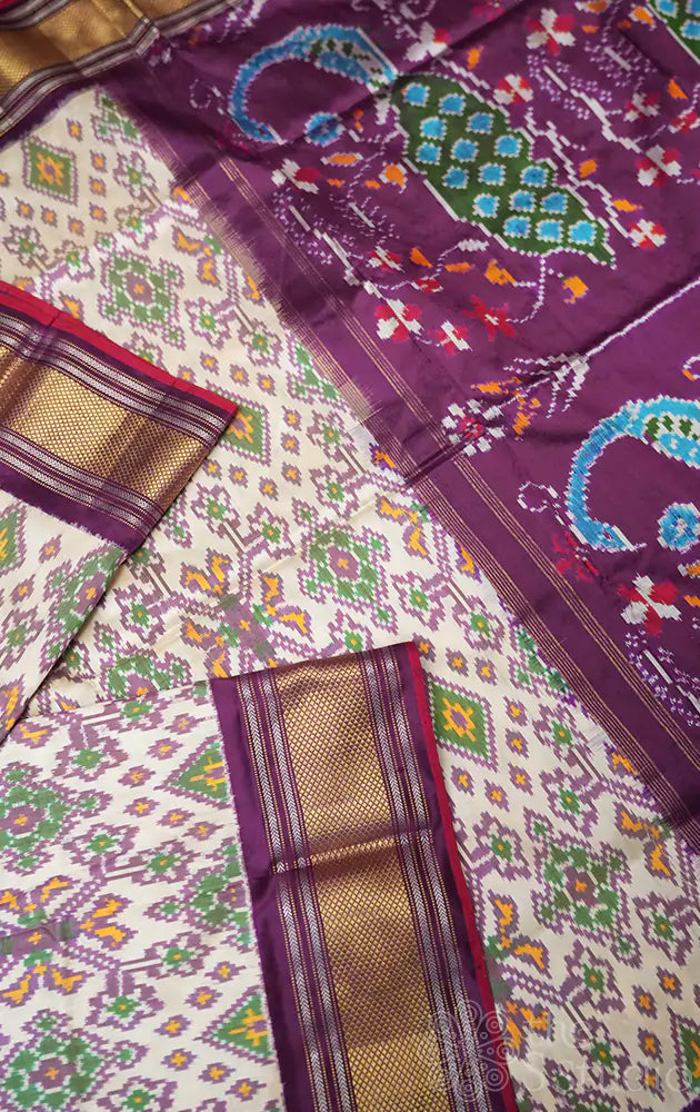 Off white and  purple ikkat silk saree with zari border