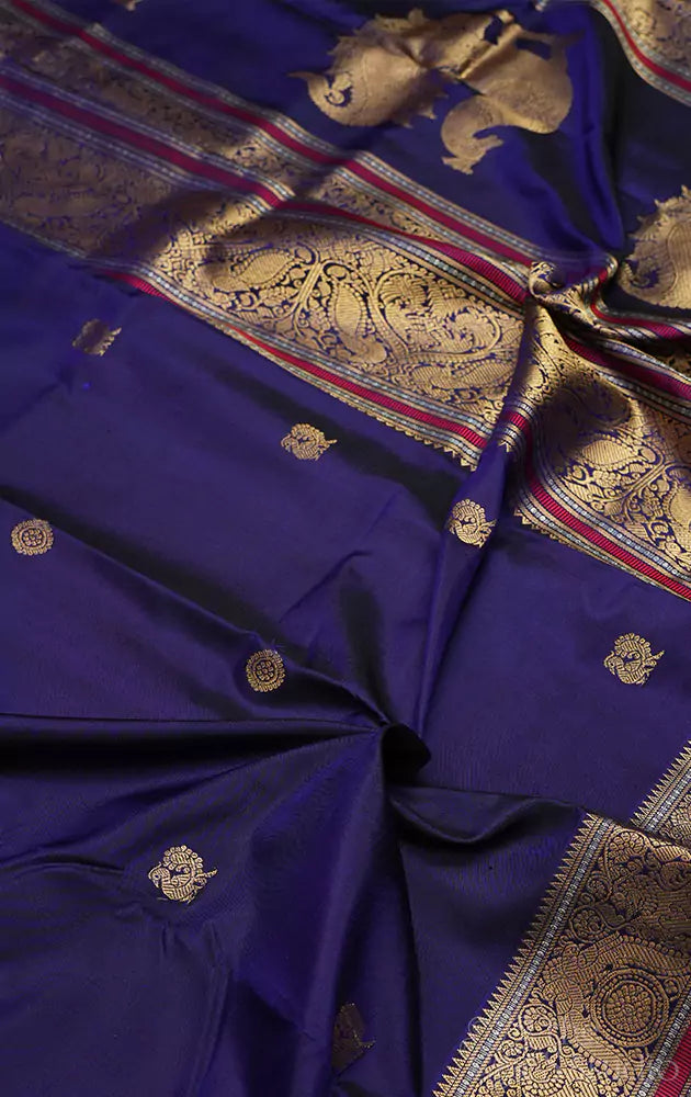 Violet kanchi silk saree with mayil chakaram buttas