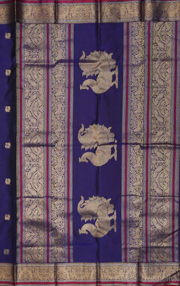 Violet kanchi silk saree with mayil chakaram buttas